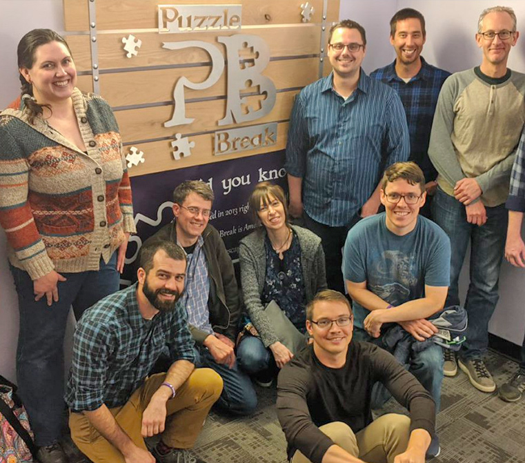 group of people in front of puzzle sign