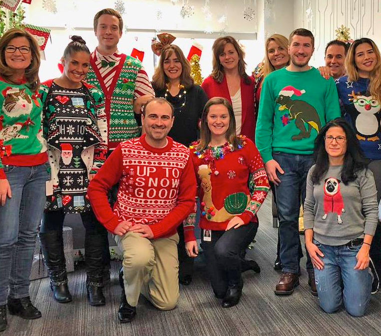 group of people wearing christmas sweaters