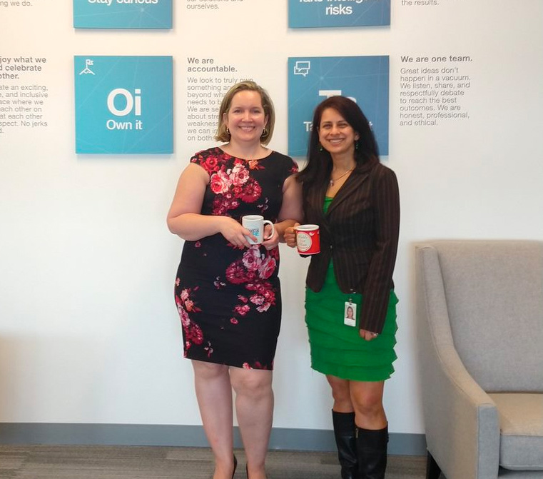 two women smiling in office