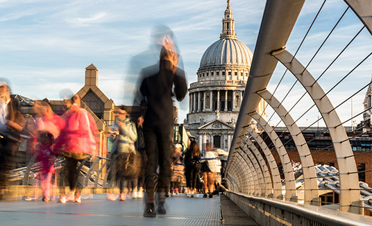 Femme entrant dans un immeuble pour en savoir plus sur l'engagement client dans le secteur des services publics