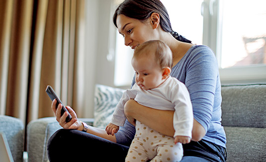 Woman with baby using proactive customer engagement solutions